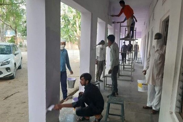 Quarantine workers paint school